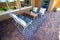 Rear Patio Furniture On Rug With Brick Pavers