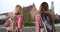 Rear portrait of 2 female backpackers in Bruges, Belgium looking around city