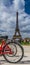 Rear red bicycle wheel over Eiffel tower on background in Paris