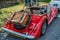 The rear of a red hand built Morgan sports car parked up in a Norfolk village