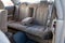 Rear seats with velours fabric upholstery in the interior of an old Japan car in beige after dry cleaning with nano floor mat