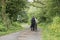 Rear view of a 1940 delivery man on a country road