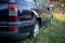 Rear view of an abandoned dark blue station wagon car