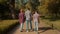 Rear view of active relaxed hearing impaired family enjoying leisure in park