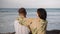 Rear view of affectionate young couple kissing on beach