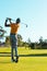 Rear view of african american young man hitting with golf club against clear sky at golf course