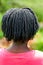 Rear view of African girl with braided hair.