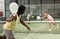 Rear view of afro american man with racket playing padel