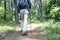 Rear view of asian traveler man with backpack and trekking pole