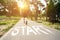 Rear View Of Athlete Passing Start Lettering On Running Path Outdoors