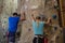 Rear view of athletes rock climbing in studio