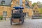 Rear view, back view of horse-drawn carriage goes to the direction of old brick buildings, Bruges, Belgium