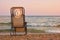 Rear view beach recliner in sea wave background.