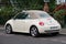 Rear view of beige Volkswagen new beetle parked in the street