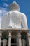 Rear view of Big Buddha golden against blue cloudy sky backgroun