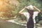 Rear view of brunette girl in park in straw hat.