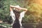 Rear view of brunette girl in park in straw hat.