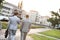 Rear view of businessmen walking at park on sunny day