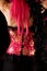 Rear view of cabaret girl in pink corset