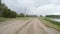 Rear view of car driving along a rural dirt road