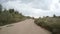 Rear view of car driving along a rural dirt road