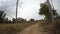 Rear view of car driving along a rural dirt road