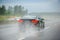 Rear view of car driving fast on German highway autobahn during rainy weather