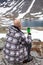 Rear view of Caucasian man drinking energy drink or coffee on the mountain peak, one climber or mountaineer in mountains