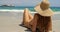 Rear view of Caucasian woman in hat relaxing on the beach 4k