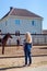 rear view of child looking at mother riding horse