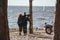 rear view of couple of bikers hugging and looking at sea motorbike