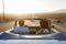 Rear View Of Couple On Road Trip Driving Classic Convertible Car Towards Sunset