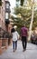 Rear View Of Couple Walking Along Urban Street In New York City