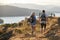 Rear View Of Couple Walking On Top Of Hill On Hike Through Countryside In Lake District UK