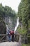 Rear View Of Couple Watching Waterfall