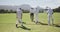 Rear view of cricket players walking on a pitch