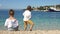 Rear view, curly boy and girl playing with pebbles on the shores of the Mediterranean. Adriatic, Croatia, Dolmatia