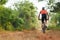 Rear View of the Cyclist Alone Riding on a Mountain Bike in Countryside Forest.