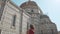 Rear view of delighted young woman admiring magnificent facade of Duomo di Firenze. Beautiful girl tourist looking into