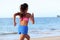 Rear View Of Determined Woman Jogging On Beach