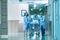 Rear view of doctors running for the surgery.  Hospital Emergency team carrying stretcher with patient through hospital hall