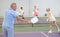 Rear view of elderly man playing pickleball on indoor court