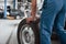 Rear view. Employee in the blue colored uniform works in the automobile salon