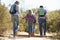 Rear View Of Family Hiking In Countryside