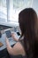 Rear view of female executive using digital tablet at desk