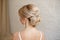 Rear view of female hairstyle middle bun with blond hair