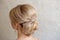 Rear view of female hairstyle middle bun with blond hair