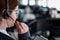 Rear view of a female helpdesk operator. An office manager with a headset answers customer calls. Unrecognizable woman