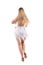 Rear view of female salsa professional dancer in fringed costume dress.