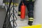 Rear view of a firefighter who climbs with a fire extinguisher along the internal escape stairs